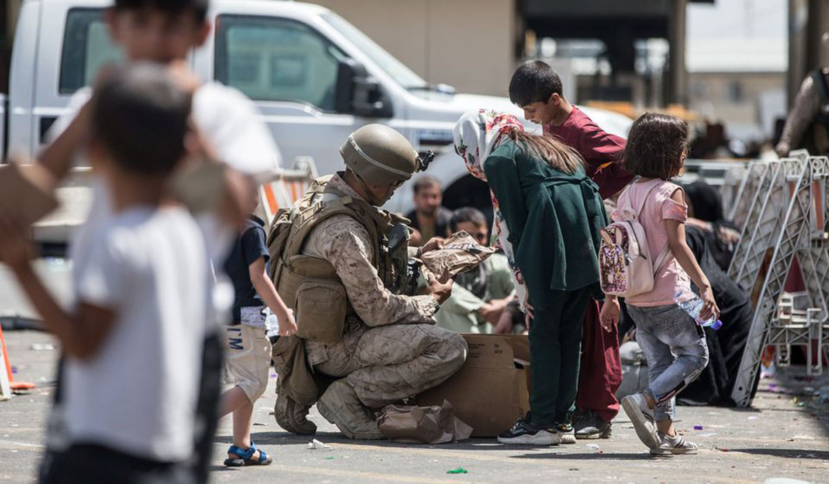Biden pledges evacuation support, Taliban beat back crowds at airport